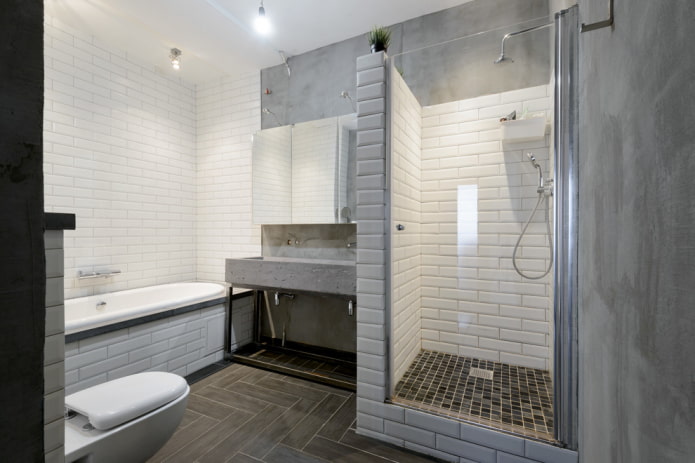 une combinaison de carrelage et de béton dans la salle de bain
