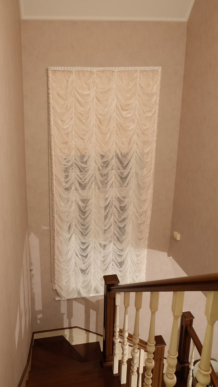 Rideaux français sur la fenêtre d'escalier