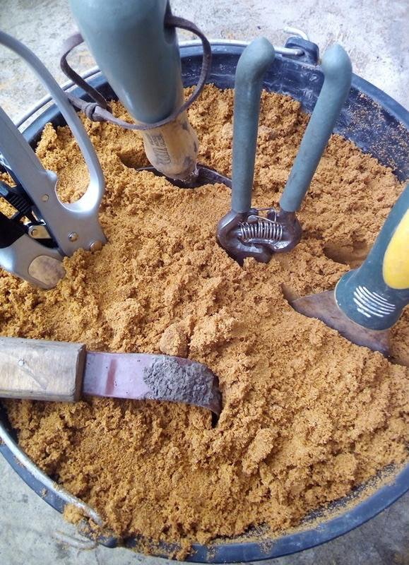 Outils dans un seau avec du sable