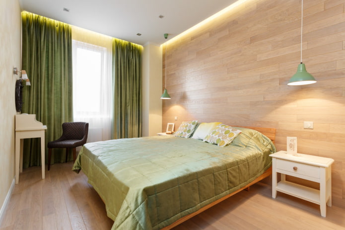lit avec un couvre-lit vert dans la chambre