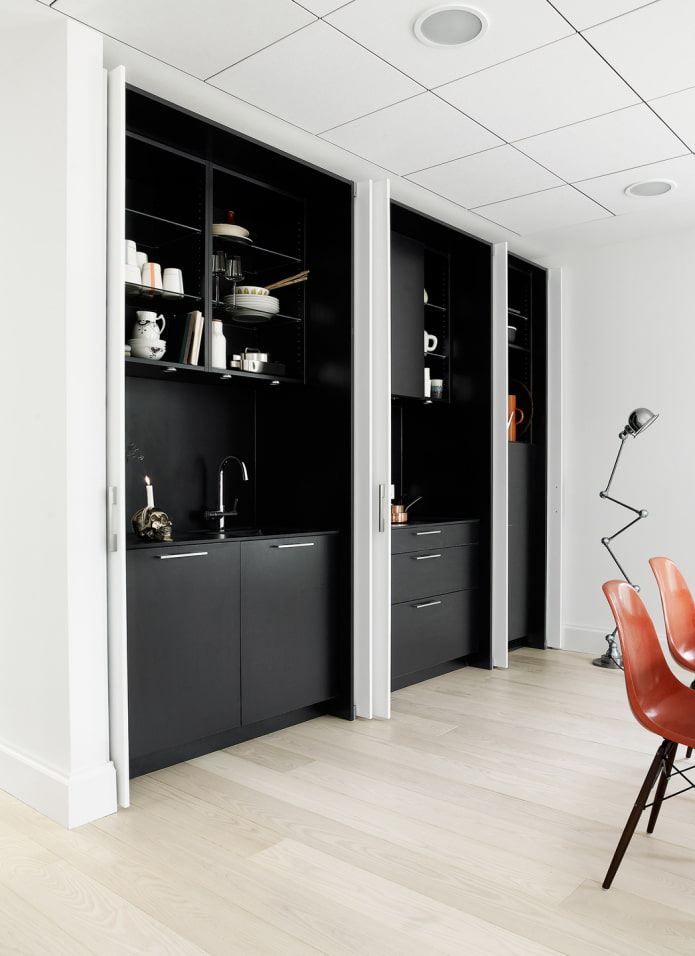 black kitchen behind sliding doors