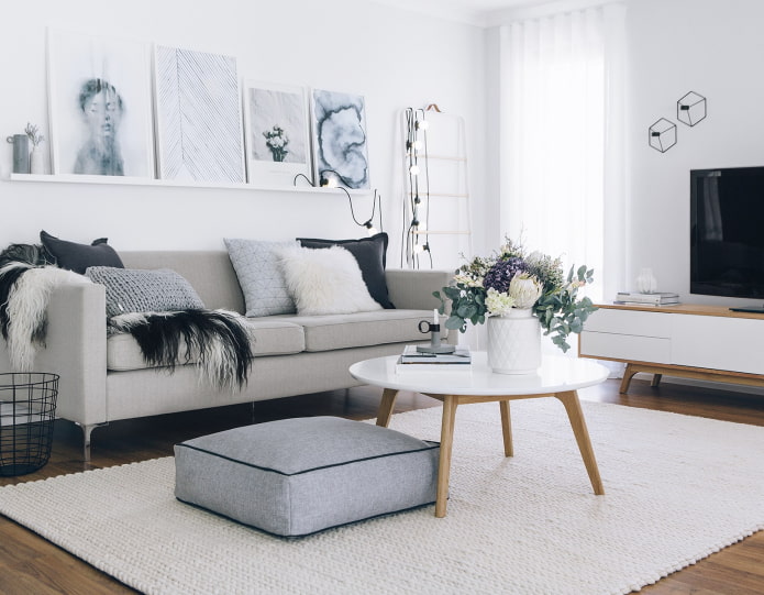 shelf with pictures above the sofa
