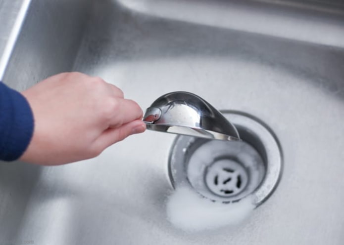 pour soda into the sink
